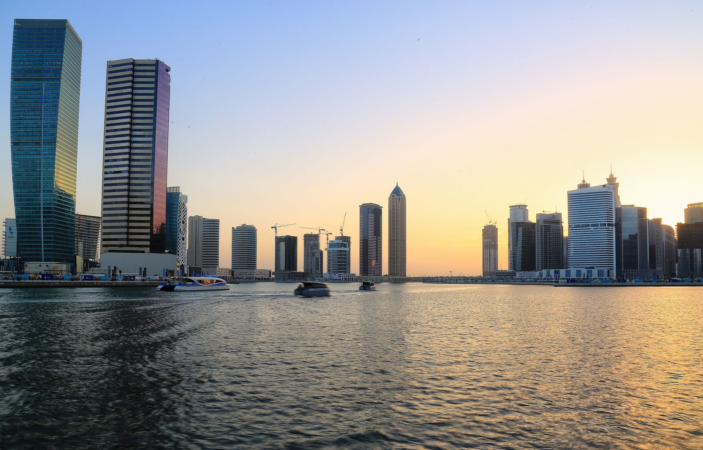 Business Bay towers along the Dubai Water Canal at dusk