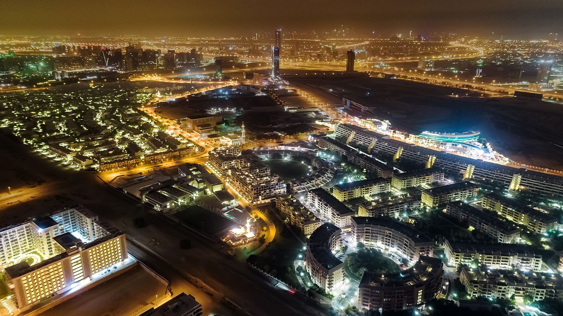 Night aerial view of the Motor City community around the Dubai Autodrome