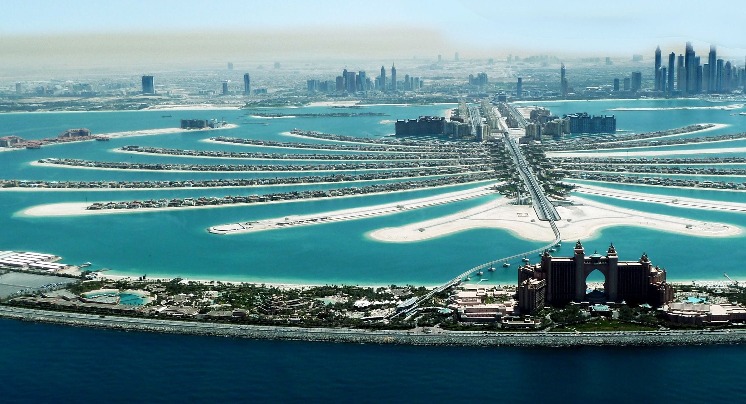 Aerial view of Palm Jumeirah with Atlantis The Palm in the foreground and the fronds of villas behind