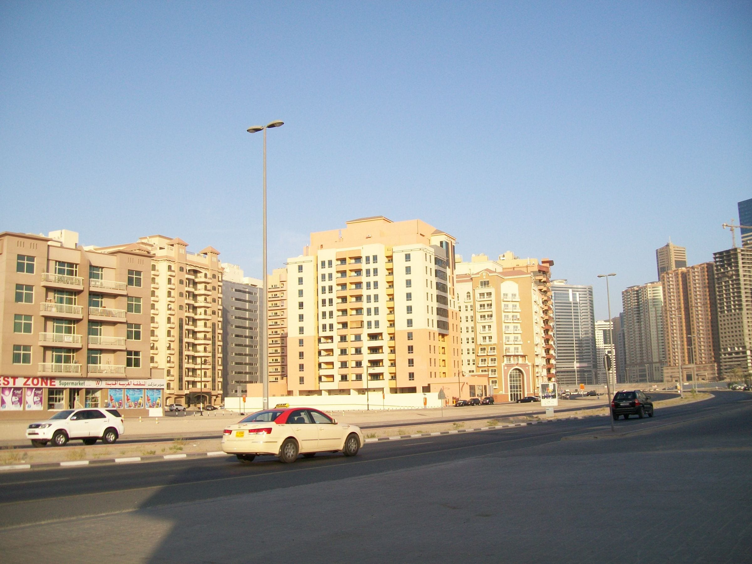 Mid-rise apartment buildings along Amman Street in Al Nahda