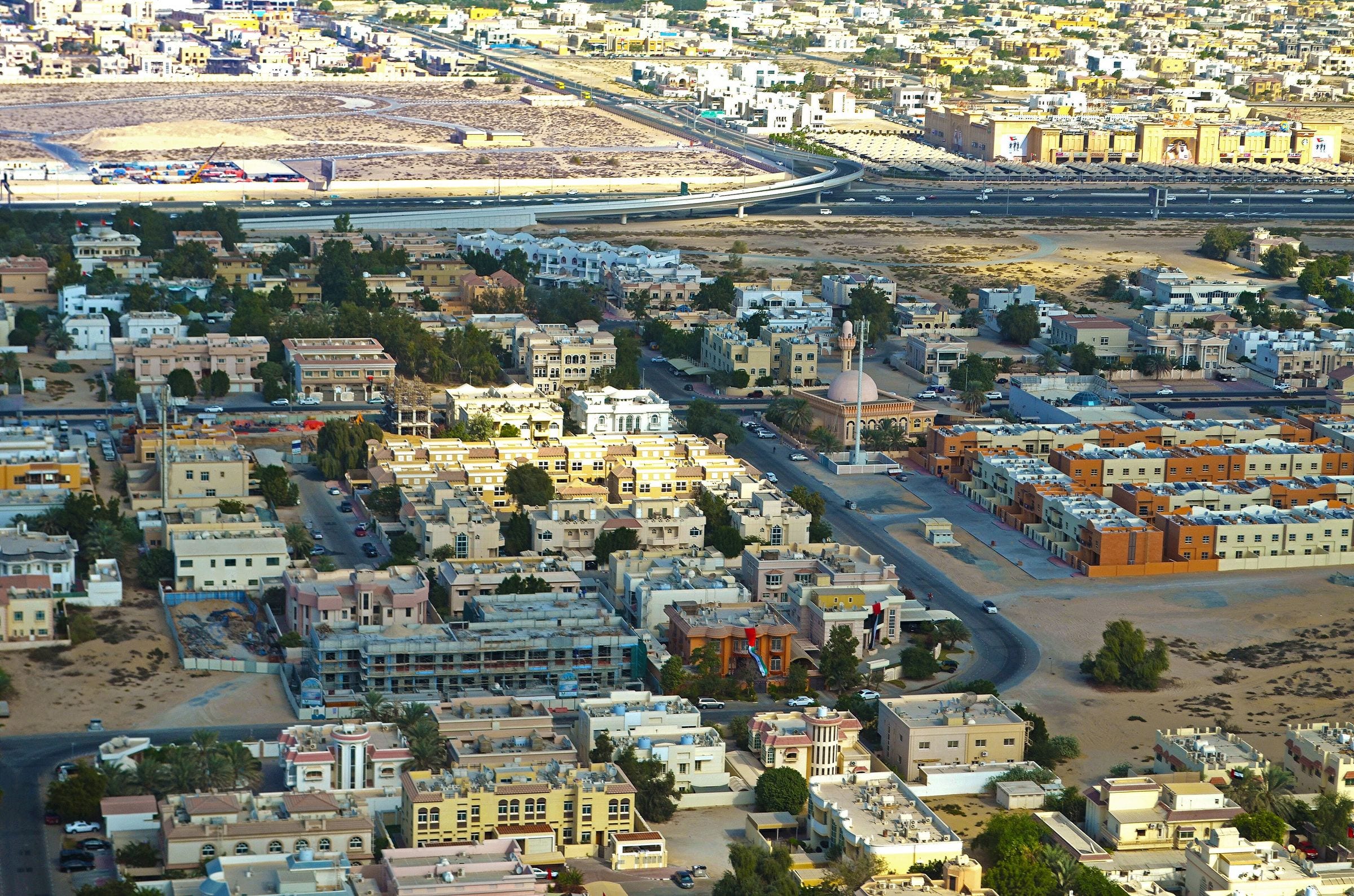 Aerial view of the low-rise villa streets of Mirdif from a plane on approach to Dubai airport